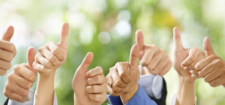 Thumbs up on green background